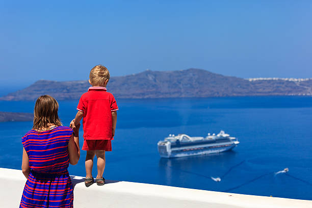 istock family looking at Santorini, Greece 471809407