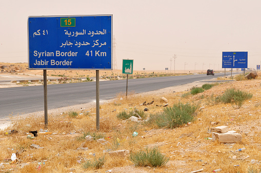 Road to the Syrian border in northern Jordan. Dusty atmosphere.