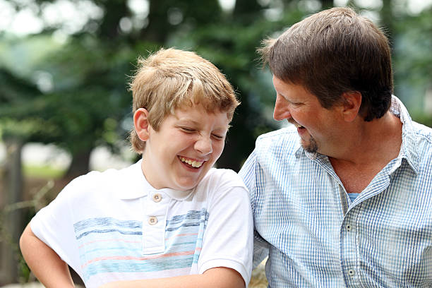 istock Father and son share a moment laughing next to each other 471812425