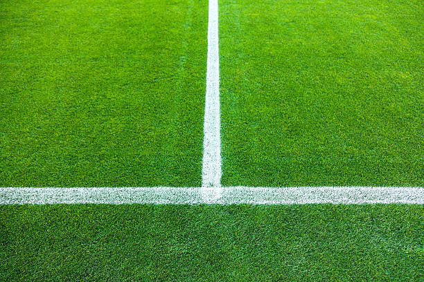 istock White stripe on the green grass field 471812659