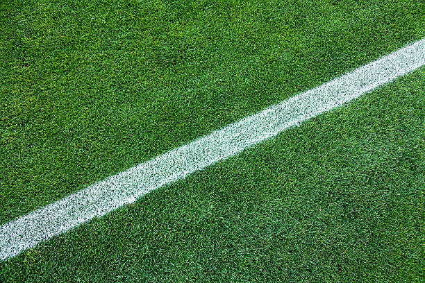 istock White stripe on the green grass field 471812763