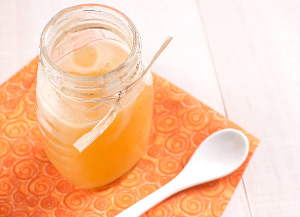 istock Jar with fresh honey on orange napkin 471813119