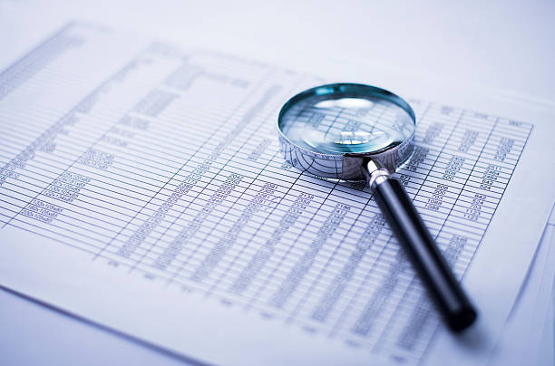 istock loupe and the financial report 471815617
