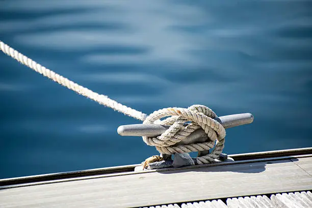 Photo of Detail image of yacht rope cleat on sailboat deck