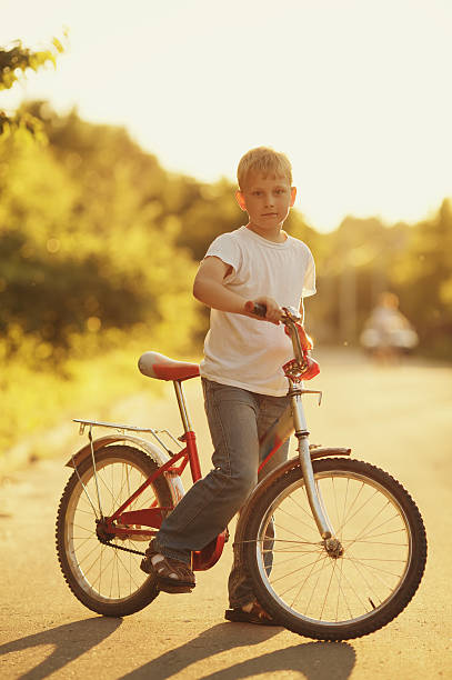 istock little boy with bike on sunset 471816095