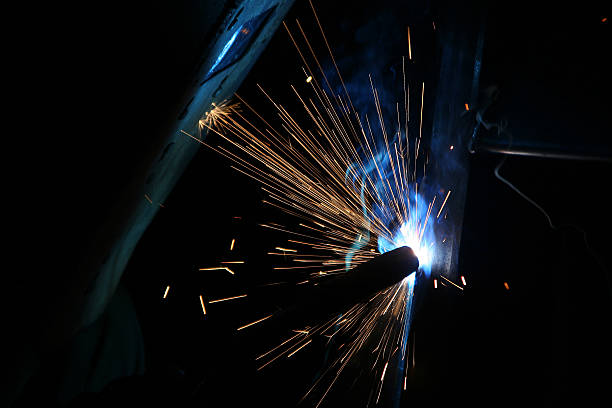 istock welder working with sparks flying around 471816353