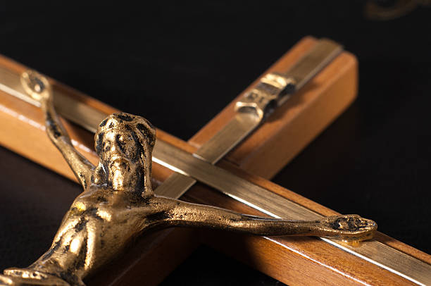 istock Crucifix with Jesus on black leather Bible 471816782