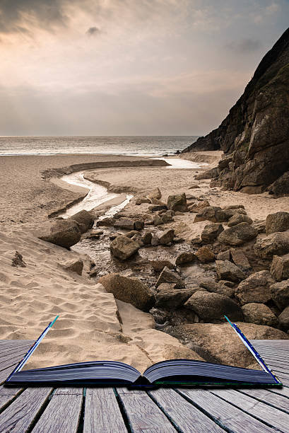 istock Creative concept pages of book Porthcurno yellow sand beach 471817203