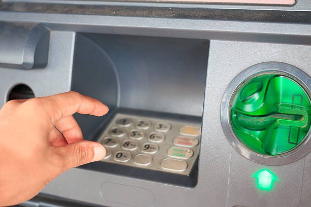 istock ATM close-up with male hand 471818280