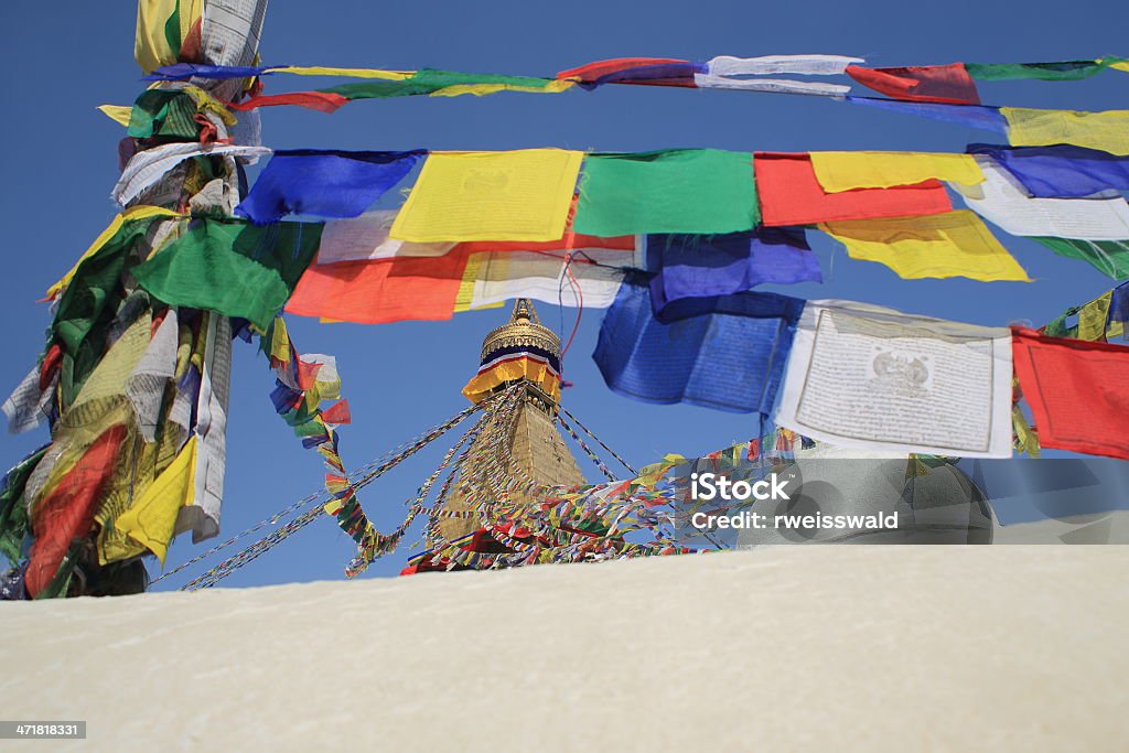 Prayer flags at the Boudhanath-Bodhnath stupa. Kathmandu-Nepal. 0308 The white big stupa of Boudhanath-Bodhnath-many colored buddhist prayer flags hanging from its 13 story golden tower-the eyes of the Buddha looking to the 4 cardinal points. Kathmandu-Nepal. Awe Stock Photo