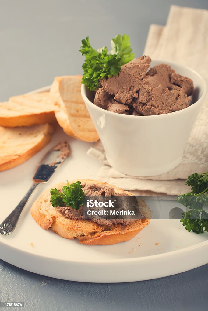 Chicken liver pate on bread and in bawl Chicken liver pate on bread and in bawl,  selective focus. Retro style toned. 2015 Stock Photo
