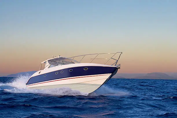 Photo of Close-up of motorboat sailing in ocean at sunrise