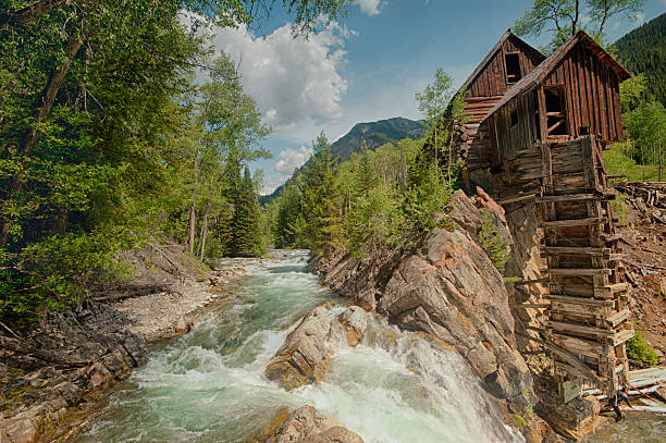 Old Crystal Mill on the river in Colorado stock photo