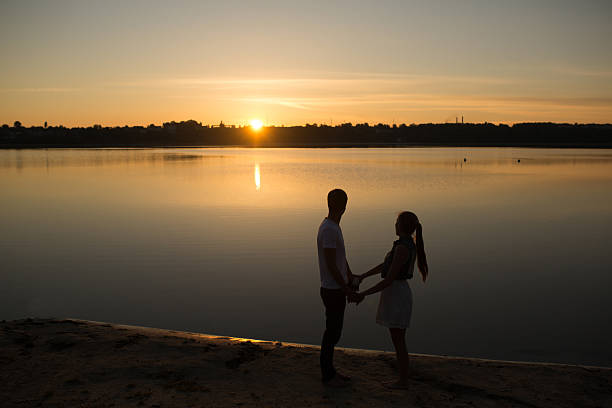 istock Couple in sunrise on the beach 471820072