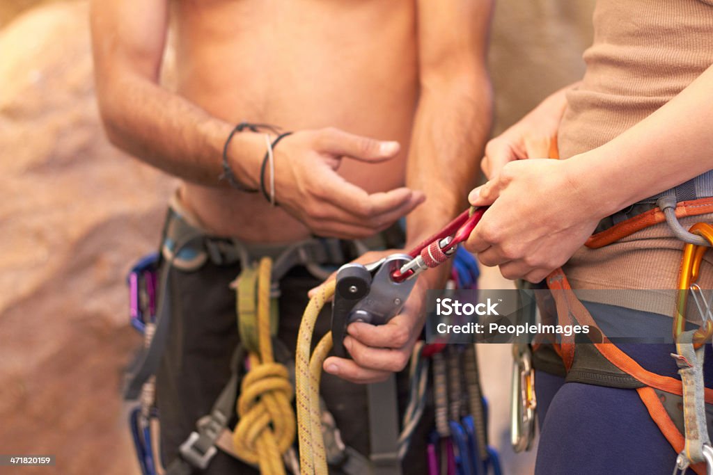 Securing their safety Cropped shot of two rock climbers adjusting their harnesseshttp://195.154.178.81/DATA/shoots/ic_781805.jpg Activity Stock Photo