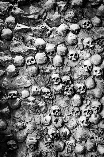 wall of skulls in black and white. Visible noise due the use of high iso because of low available light.