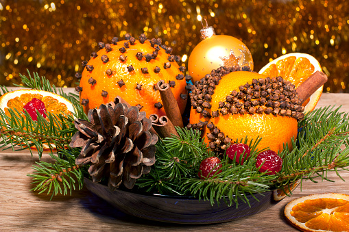 Christmas decorative composition with orange pomanders close ap on a wooden background