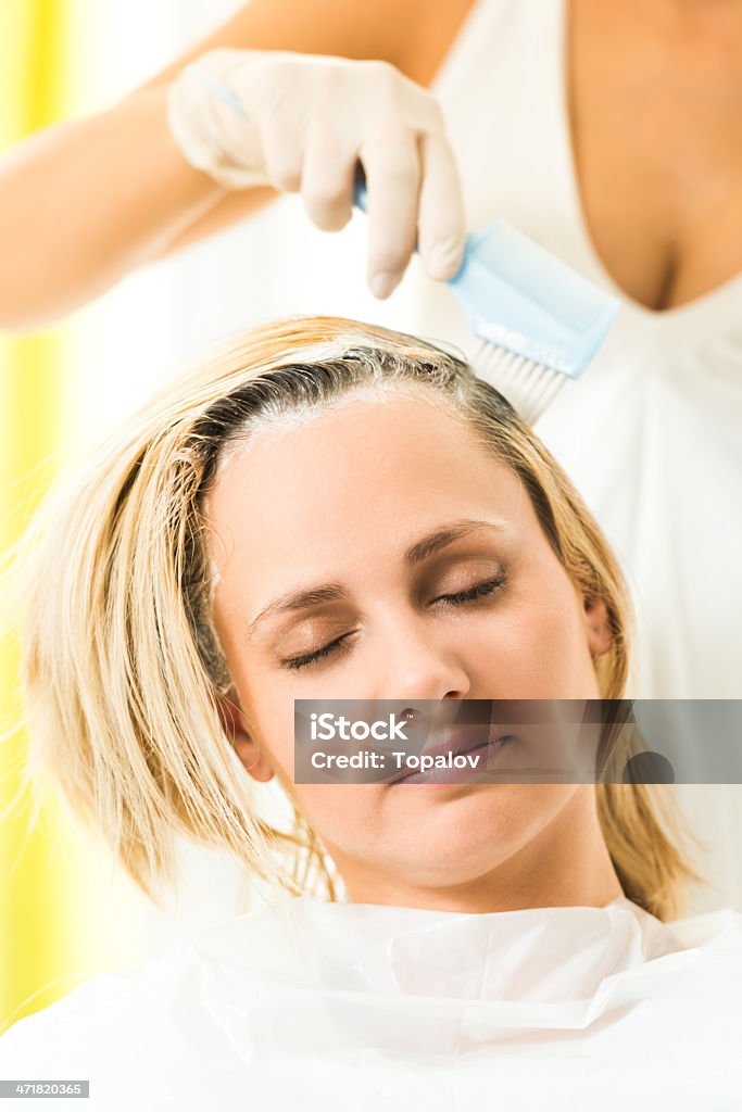 Hair Coloring Hair dye of a blonde woman hair with brush 30-34 Years Stock Photo