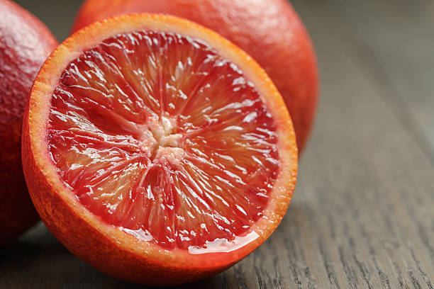istock ripe red oranges on wooden table 471823152