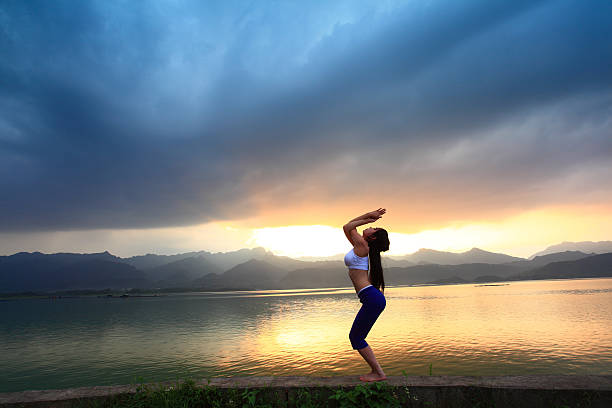 istock Young woman practicing yoga 471823181
