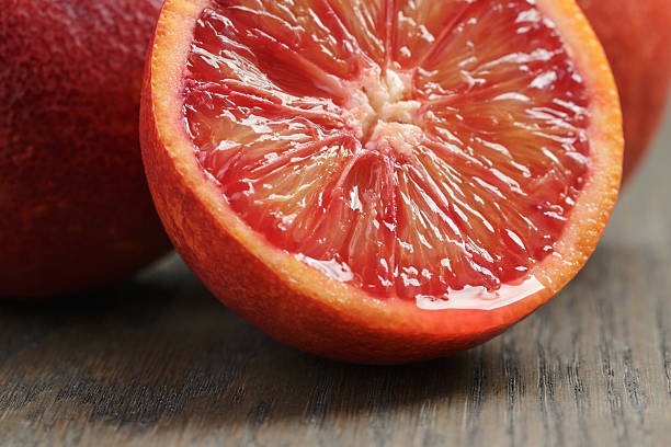 istock ripe red oranges on wooden table 471823226