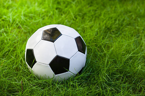 istock Soccer ball on grass 471823578