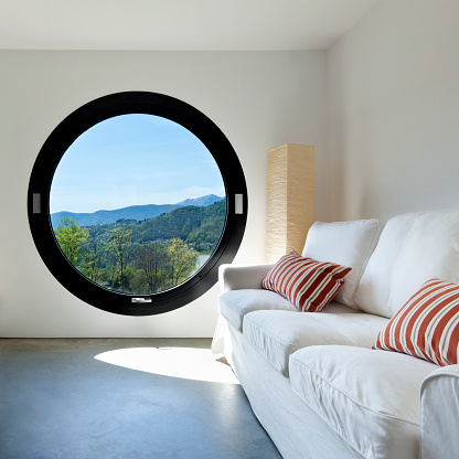 beautiful modern house in cement ,room with large porthole