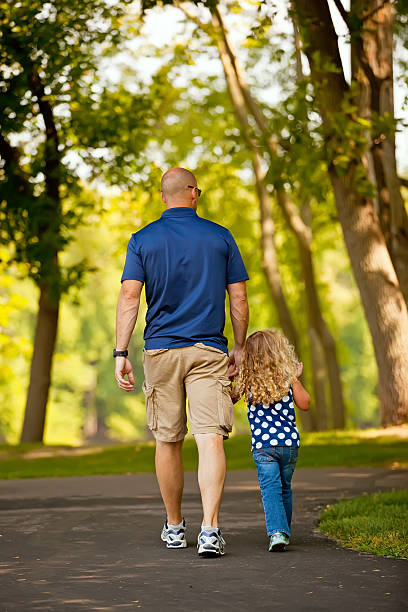 istock Father & Daughter Walking at Park 471824161