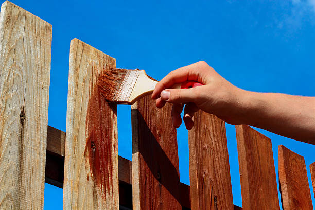 Painting wooden fence stock photo