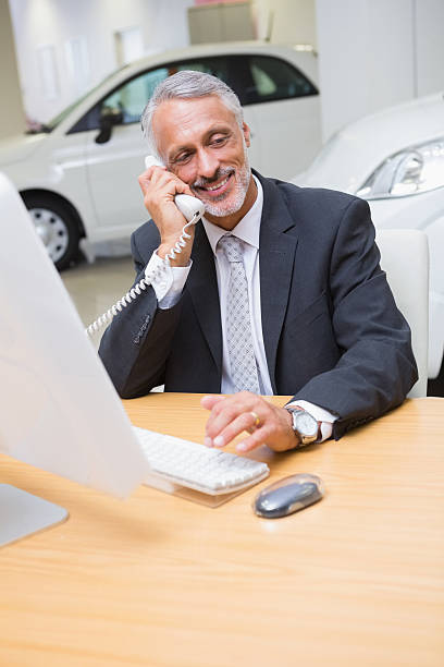 istock Smiling businessman making a phone call 471825066
