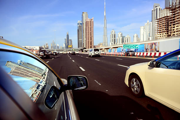 Dubai Taxi, cityscape reflected in car window