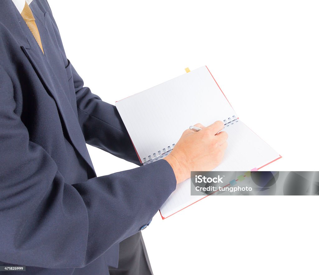 business man writing on notebook Adult Stock Photo