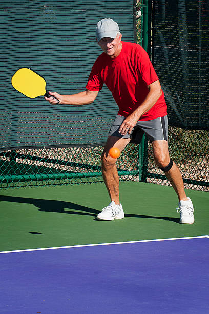 istock Pickleball Action - Senior Man Hitting Forehand Shot 471826285