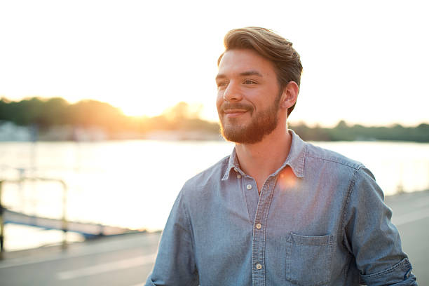 istock Young man enjoying sunset by the river. 471829306