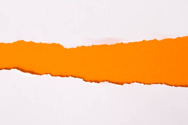 istock Ripped white paper revealing orange-colored background 471829399