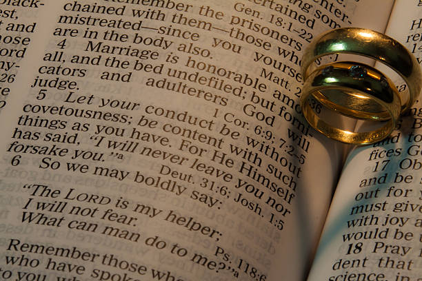 istock wedding rings making heart shaped shadows on bible pages 471829431