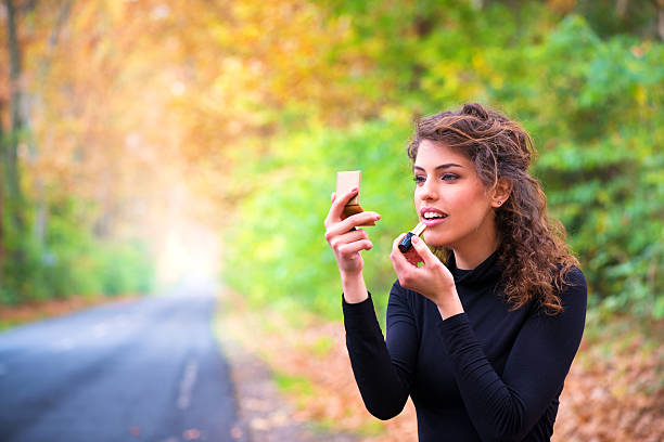 istock Young woman applying her makeup 471830287
