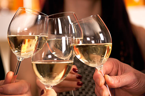 istock Clicking glasses with white wine. 471830315