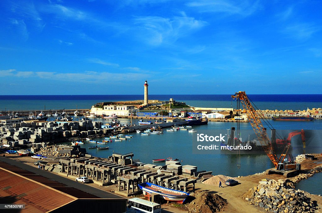 Cherchell, Algeria: harbor - general view Cherchell - Tipasa wilaya, Algeria / Algérie: harbor - general view - crane, boats, lighthouse and the Mediterranean sea  Algeria Stock Photo