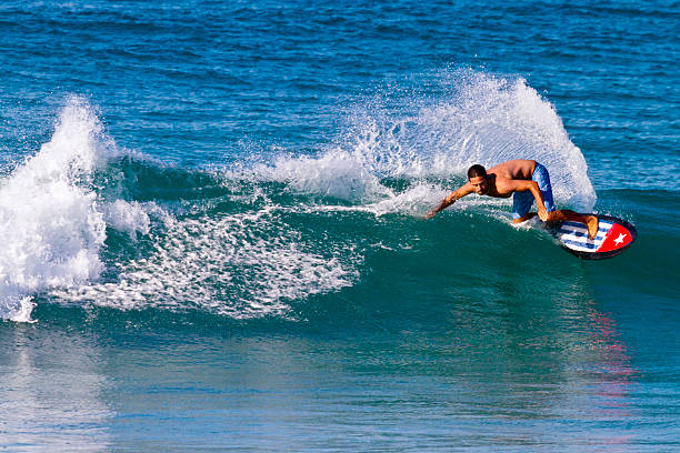 A surfer stretches to stay on board