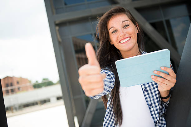 Young happy woman with thumbs up stock photo