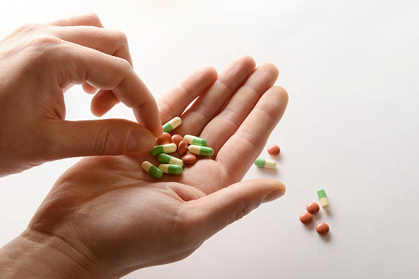 istock Men's hand holding pills, capsule - medicine 471832276