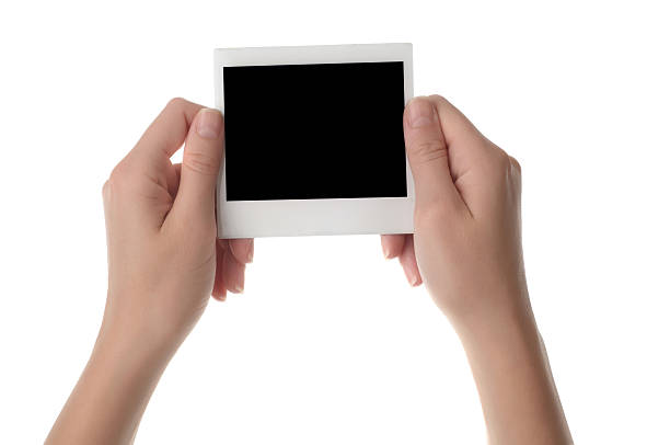 istock Female hands holding blank instant photo 471832912