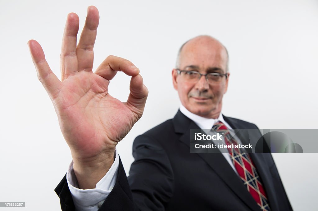 Businessman Ok Businessman making the ok sign directly in to the camera. Active Seniors Stock Photo