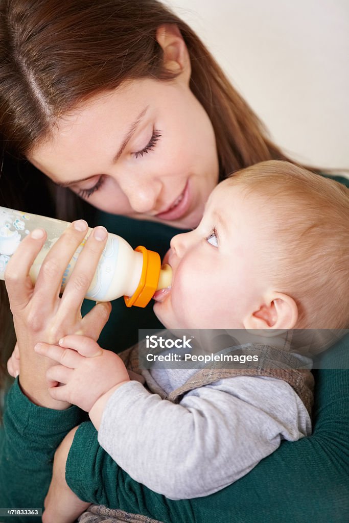 Nurturing love Pretty young mother bottle-feeding her infant sonhttp://195.154.178.81/DATA/i_collage/pi/shoots/781386.jpg Baby - Human Age Stock Photo