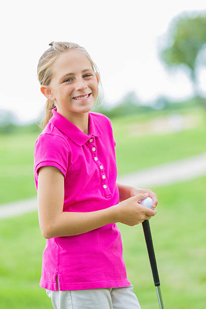 istock Happy little girl playing golf on course 471833433