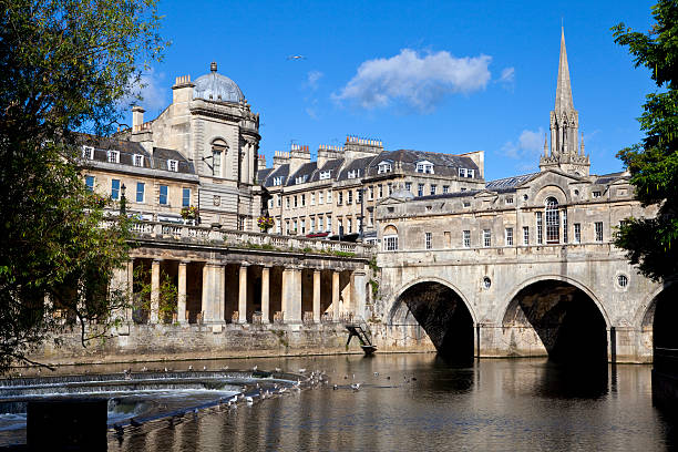 Pulteney Bridge and the River Avon Pulteney Bridge and the River Avon in Bath.  St Michael's Church can be seen in the background. bath england photos stock pictures, royalty-free photos & images