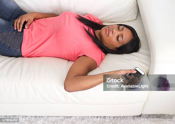 African American Woman Asleep On Couch With Phone Stock Photo - Download Image Now - 2015, 30-39 Years, Adult