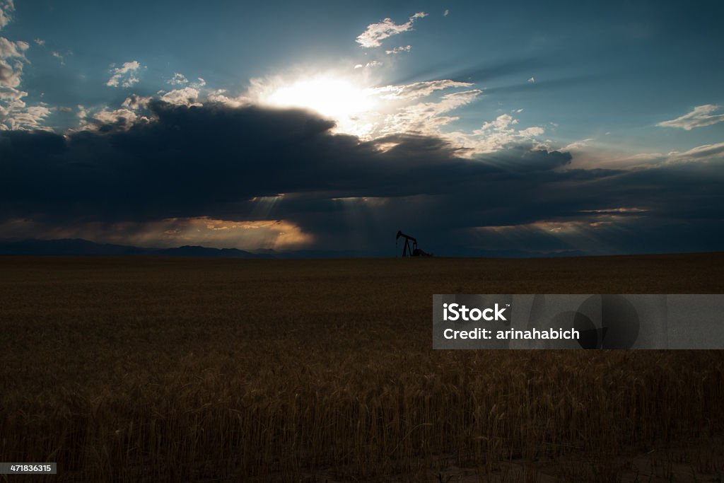 Pumpjack A pumpjack silhoutte with dramatic sunset. Agricultural Machinery Stock Photo