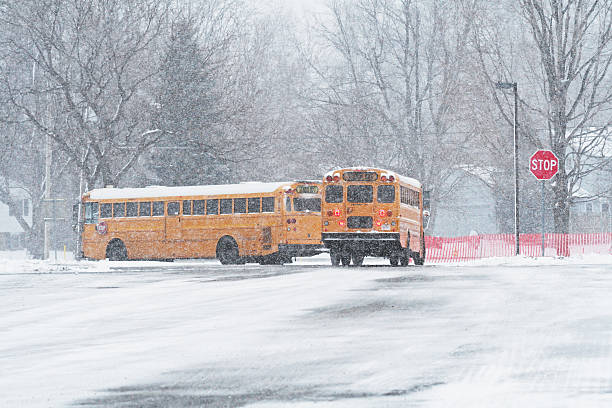 istock Blizzard School Buses Leaving Parking Lot 471836873